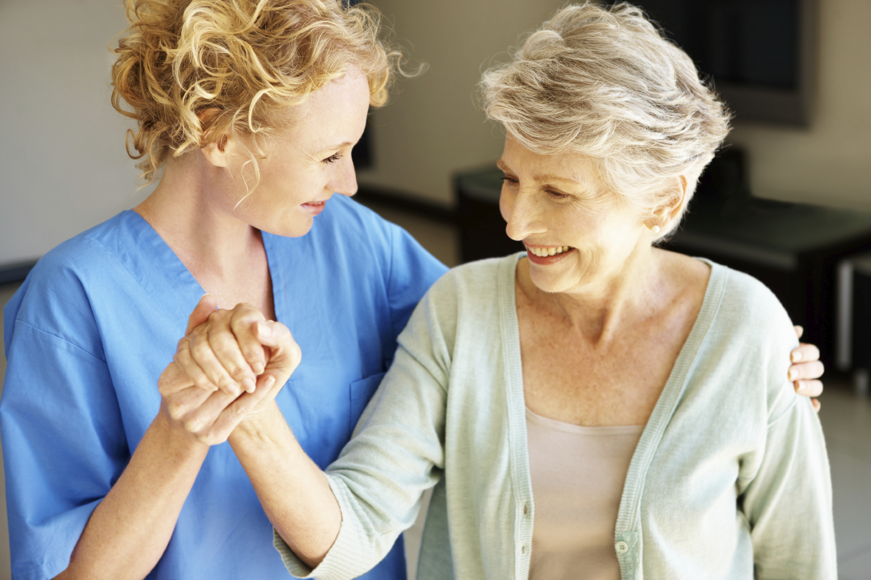 Nurse assists older female patient