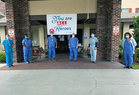 Elizabeth King, a nurse educator with the James A. Haley Veterans’ Hospital (pictured second from left), stands outside of a community nursing home with the other members of her strike team. 